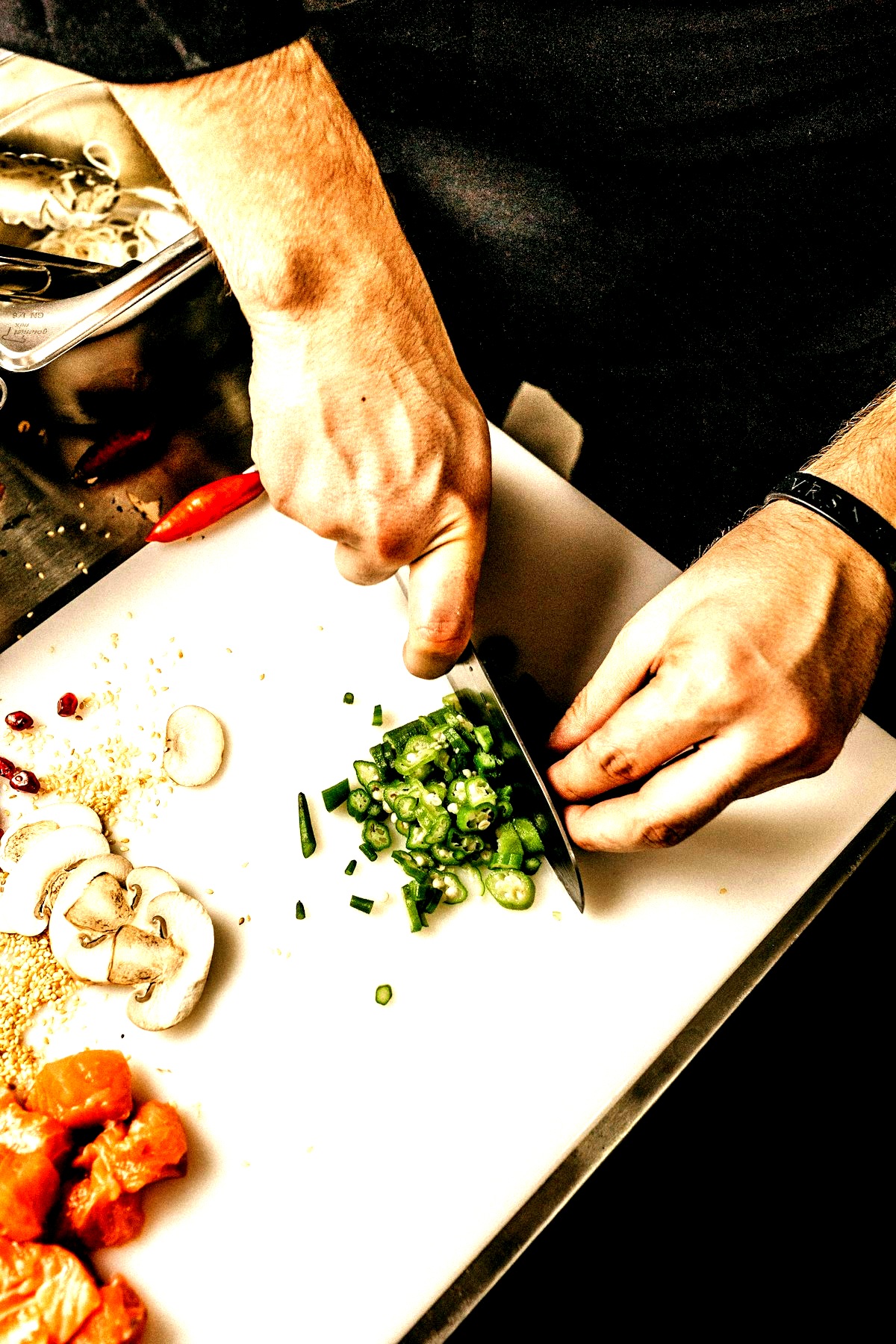 Chef's hands chopping fresh ingredients