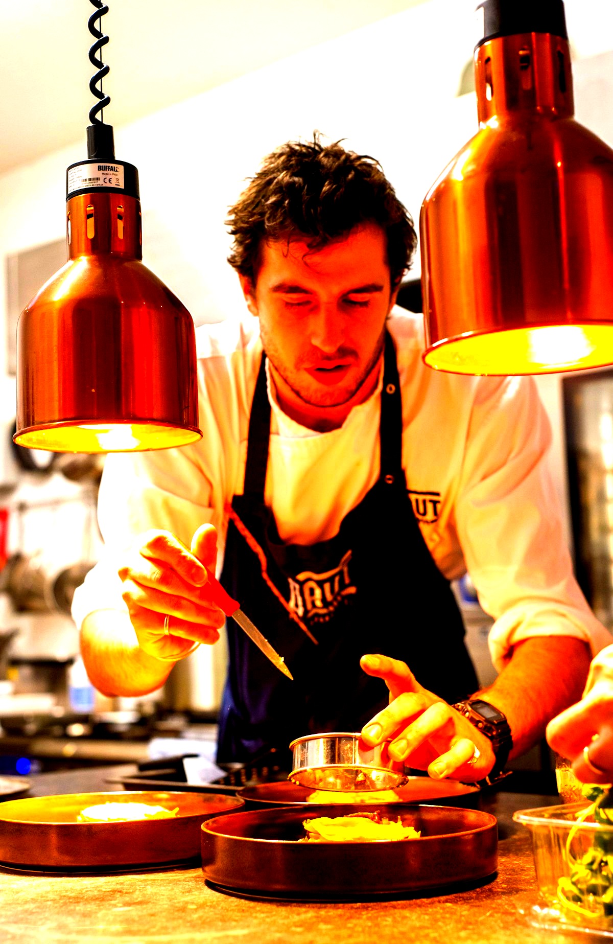 Chef plating dishes at the pass