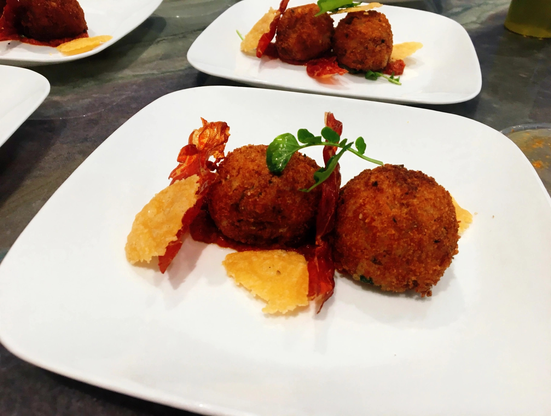 Crispy arancini with prosciutto crisps and parmesan tuiles