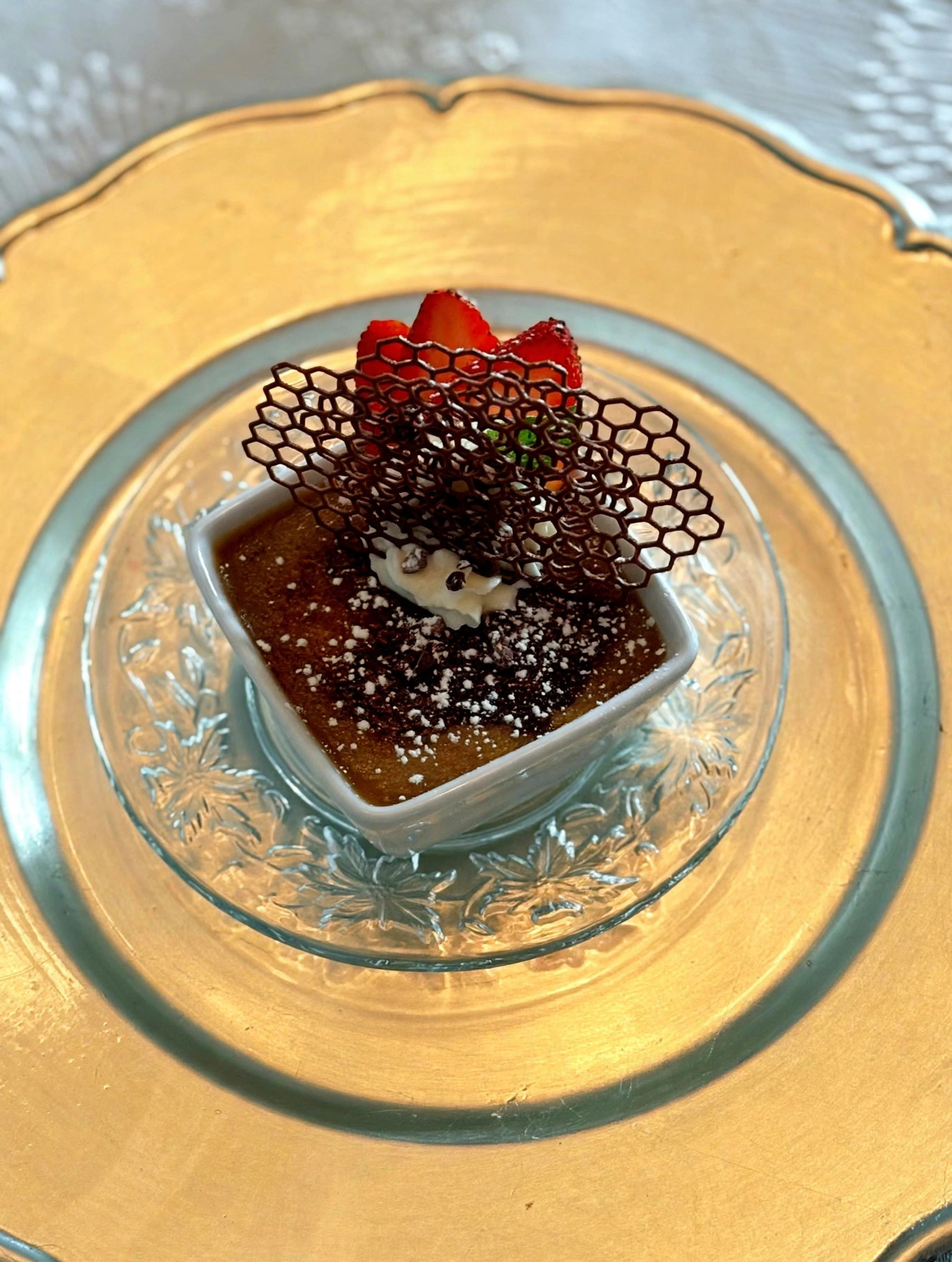 Chocolate pot de crème with chocolate tuile and strawberries
