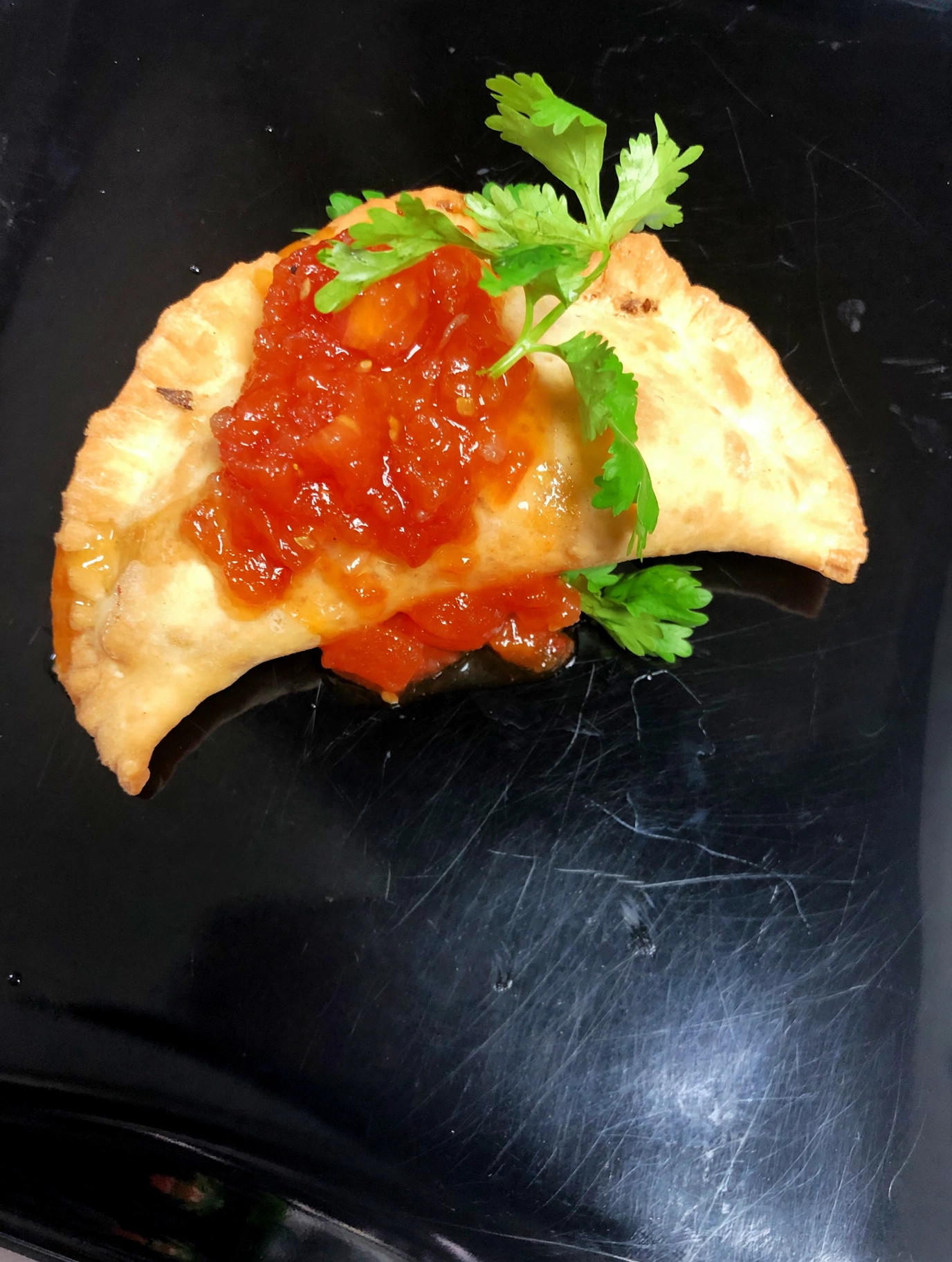Empanada with fresh salsa and cilantro