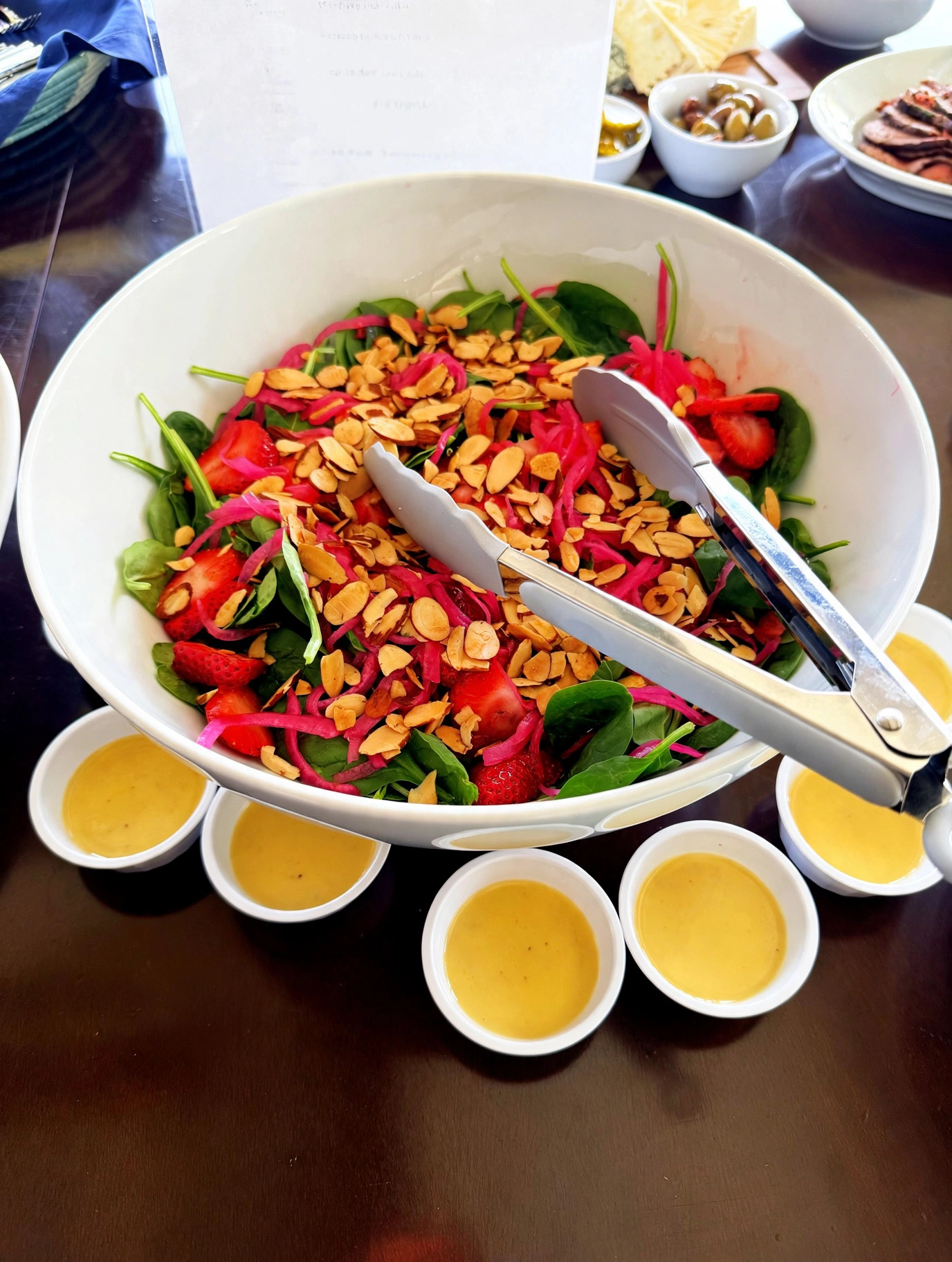 Strawberry spinach salad with almonds and pickled onion