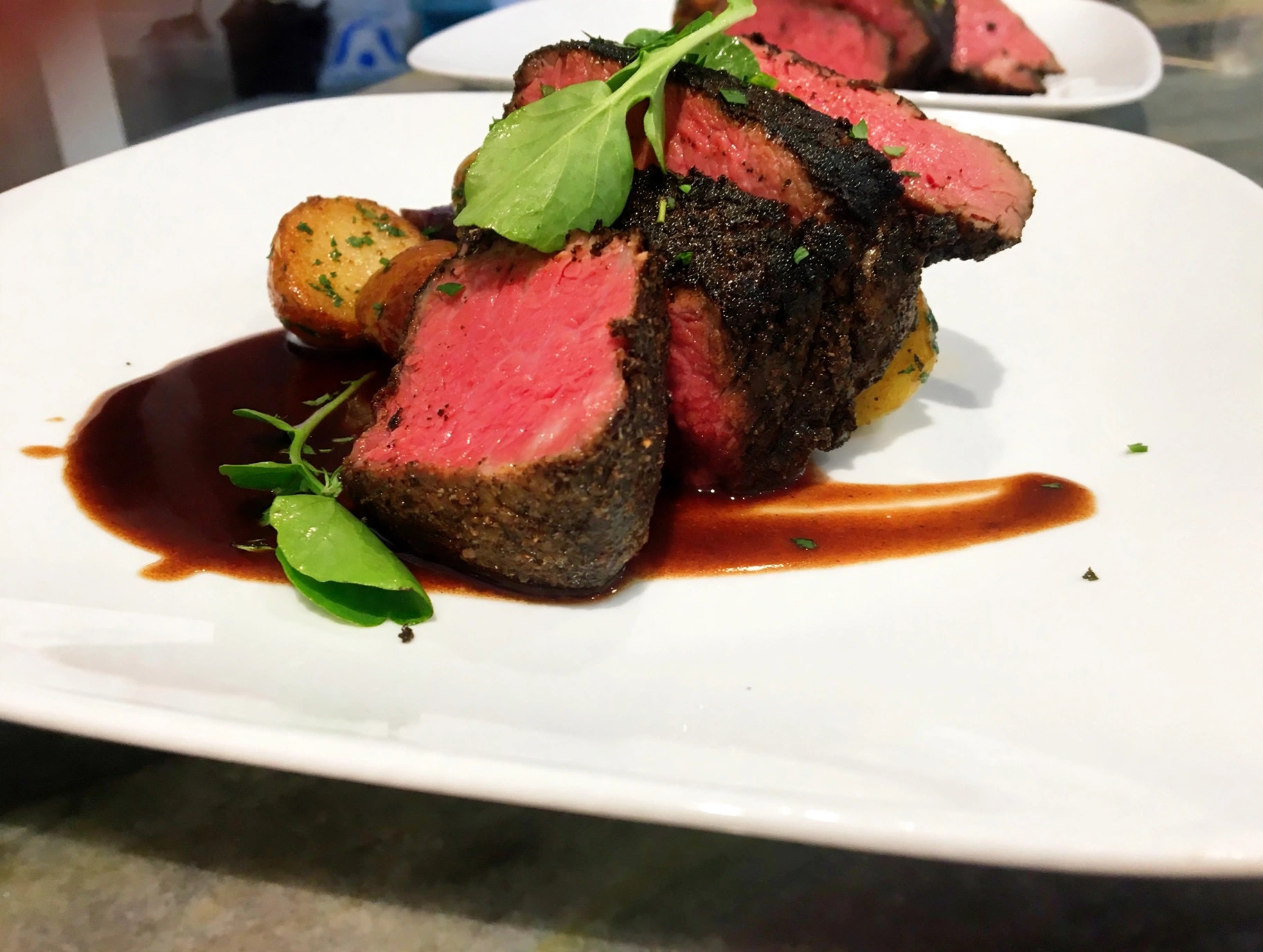 Sliced beef tenderloin with red wine jus