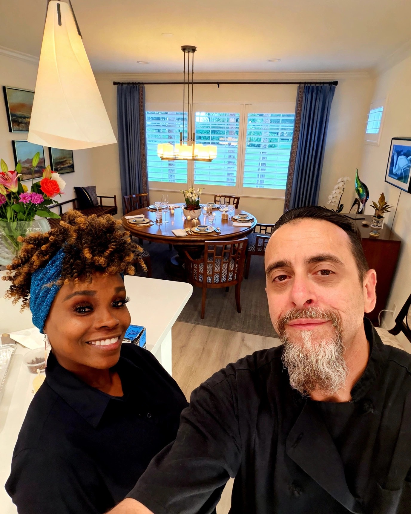 Chef Tony and his wife smiling in a warmly lit dining room